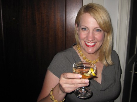 woman with blonde hair holding a cocktail