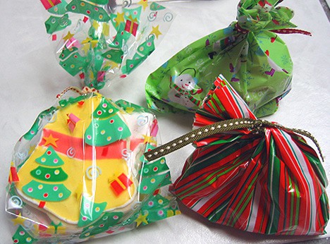 Decorated Sugar Cookies, Chocolate Covered Pretzels and Oreo Truffles wrapped in cellophane bags