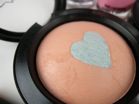 MAC blush in a sheer peach with a shimmery green heart
