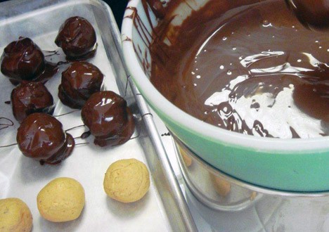 chocolate covered ball on a paper-lined cookie sheet