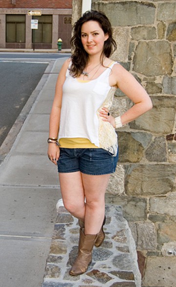 woman wearing white lacy tank top with denim shorts