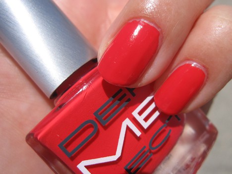 A hand with a bright red with pink undertone nail polish