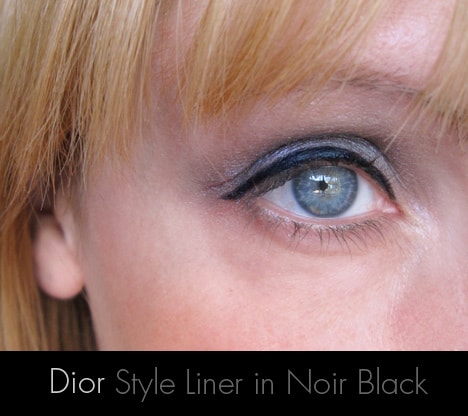 A close up image of woman's one eye applying Dior Style Liner in Noir Black