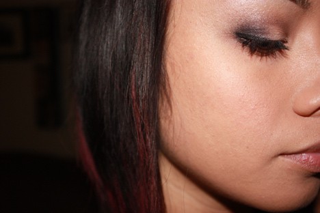Side view of a woman wearing eyeshadow and blush