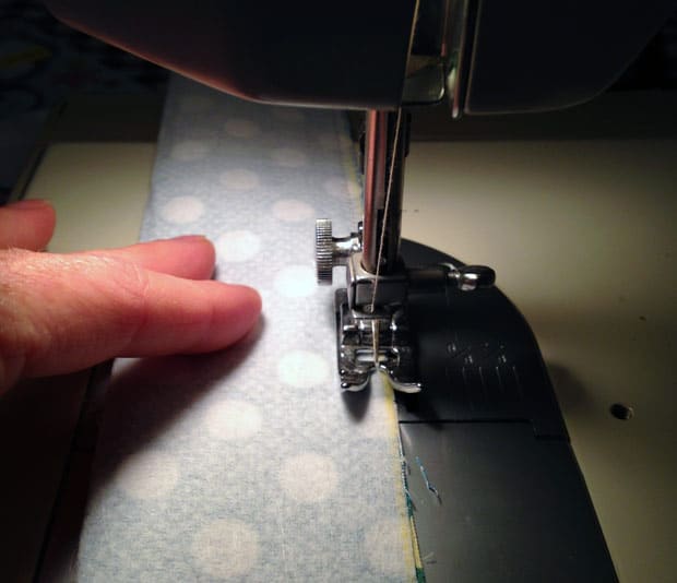 sewing machine sewing blue fabric