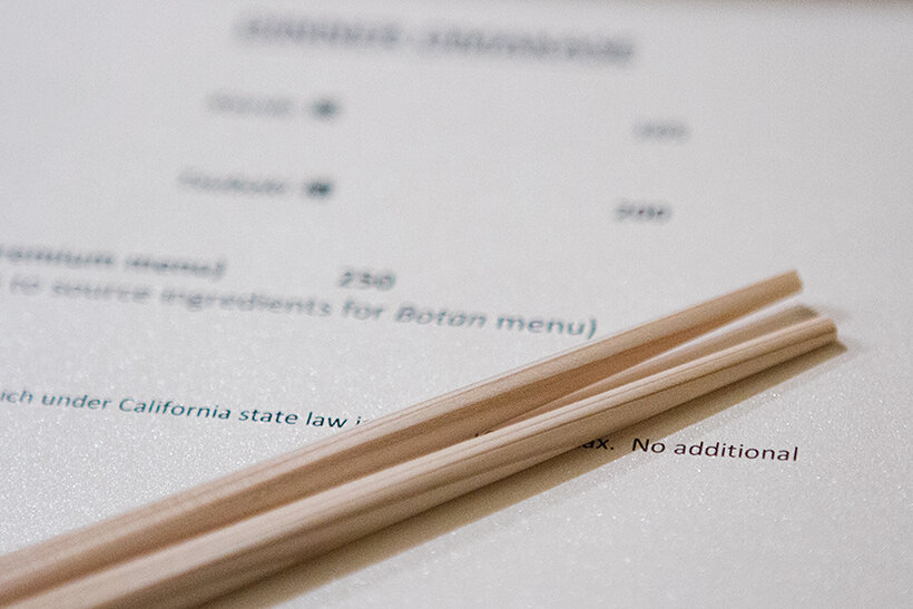 Q sushi menu with chopsticks