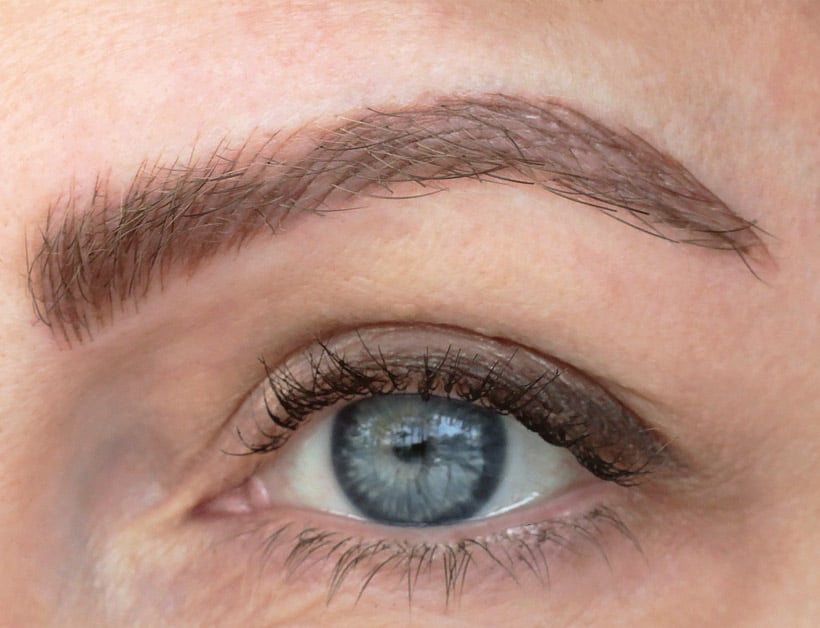close up image of a woman's eye with microbladed eyebrows