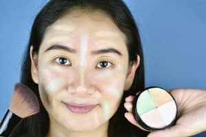woman with different color correcting concealers on her face