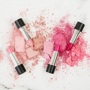 lipstick and pink blush on a white counter