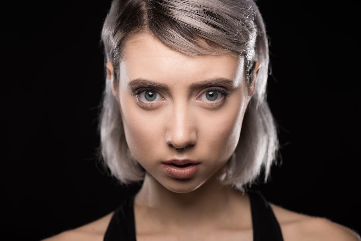 woman with large prominent eyes staring straight at the camera