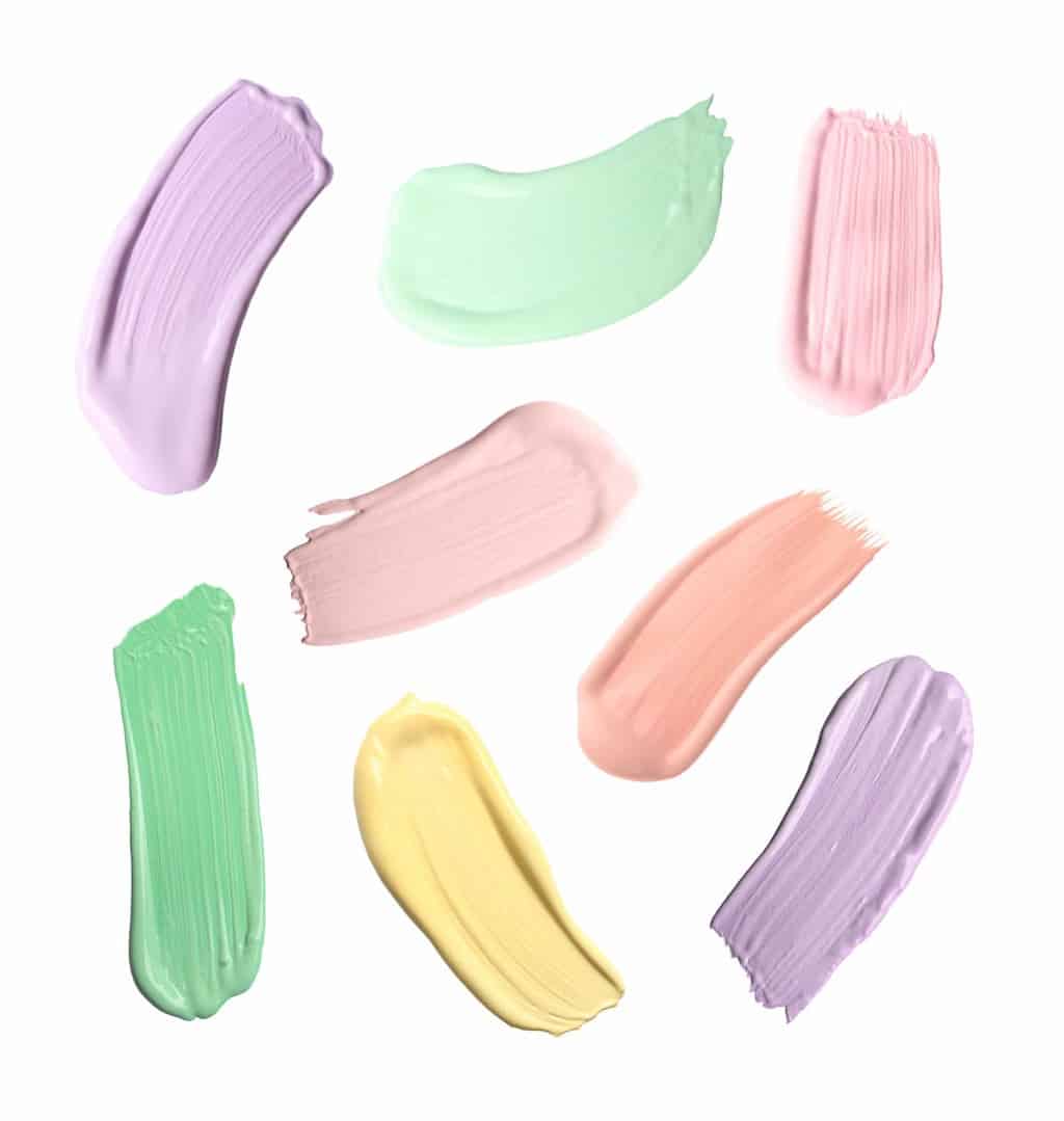 swatches of color correcting concealers in green, purple, pink and yellow