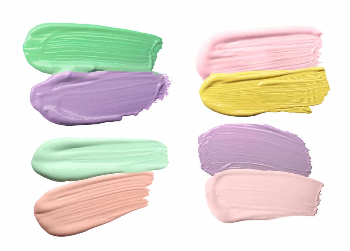swatches of color correcting concealers in green, purple, pink and yellow