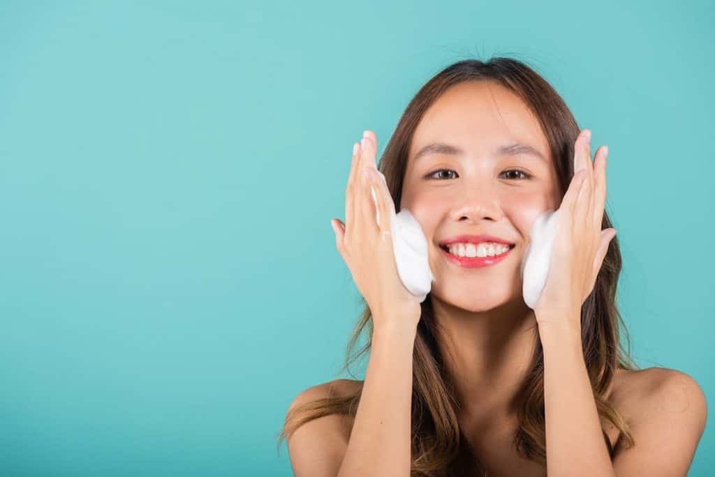Asian woman face wash exfoliate scrub soap foam with skincare cleansing