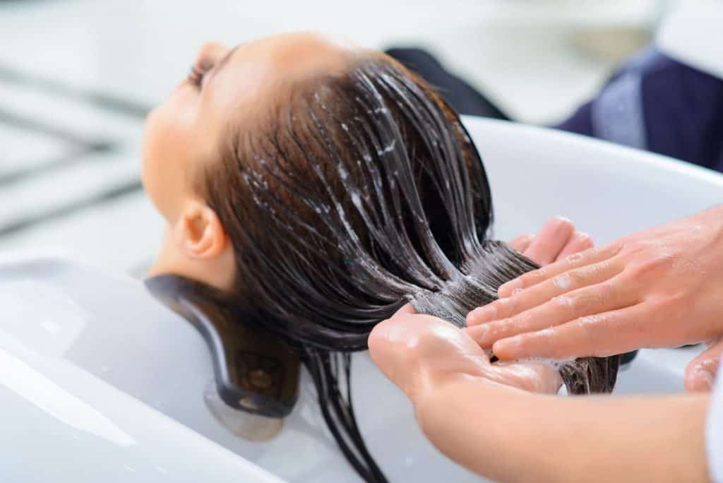 Woman's hair is having a keratin treatment at a salon