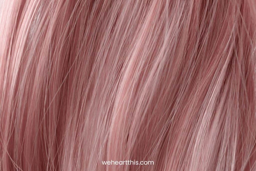 a close up image of hair strands with rose gold color