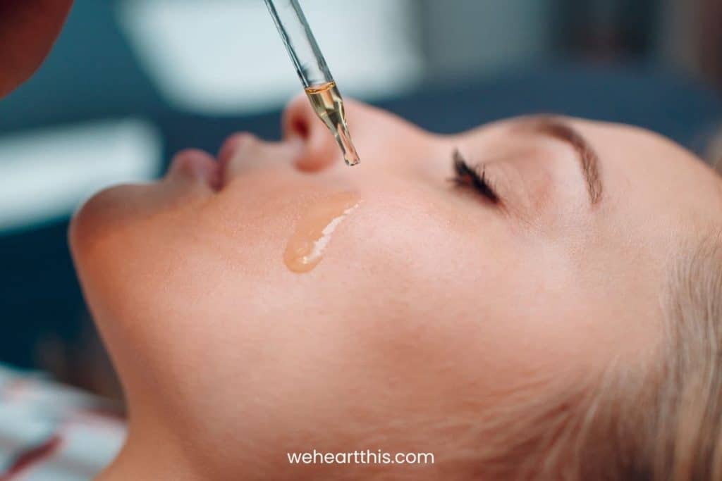 a woman applying the best oil for gua sha for combination skin