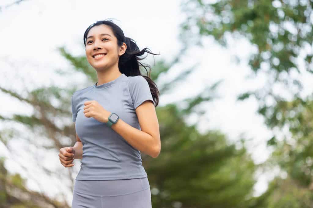 A young woman jogging in the park.
