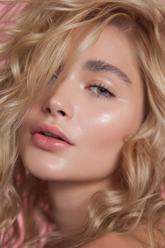 close up photo of a woman with light dewy glow makeup