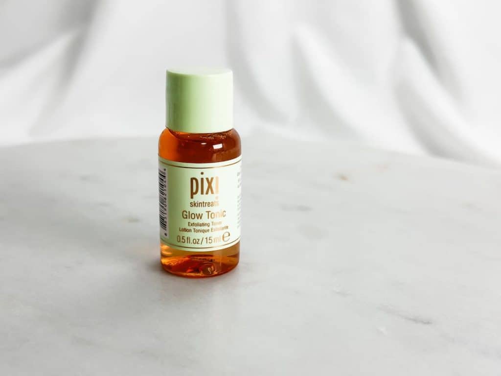 Pixi skintreats glow tonic exfoliating toner product on top of a white table