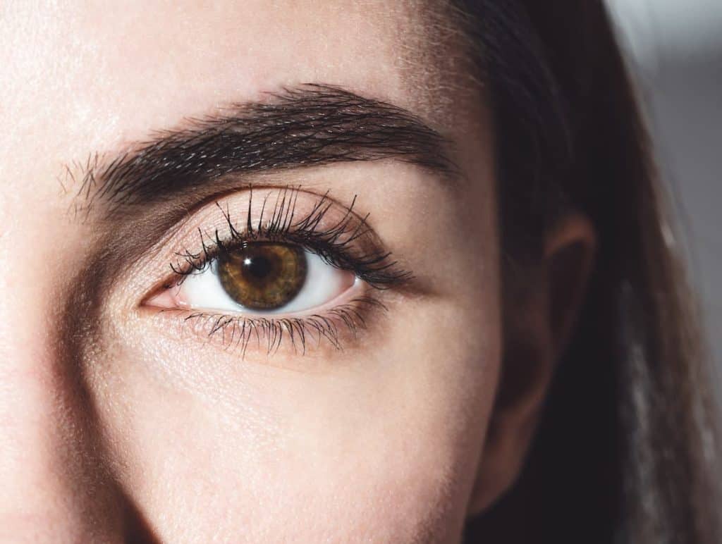 A close up of a woman's dark brown eyes.