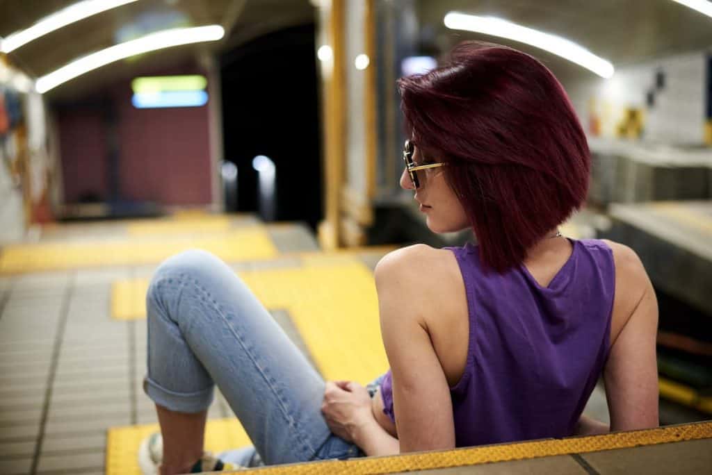 streetstyle photo of a woman with short, burgundy-colored hair