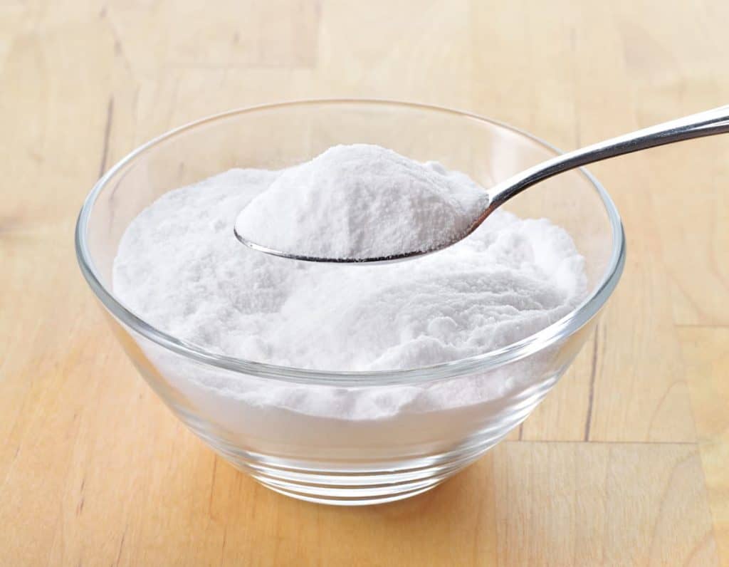 Close-up of baking soda on spoon and bowl