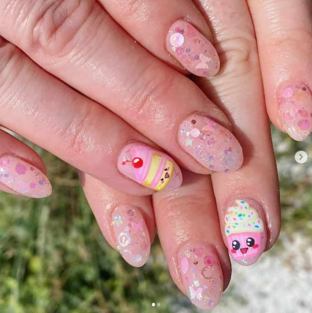 A closeup of a woman's hands with a sheer glitter base that has fancy stickers in butterflies, stars, and circles