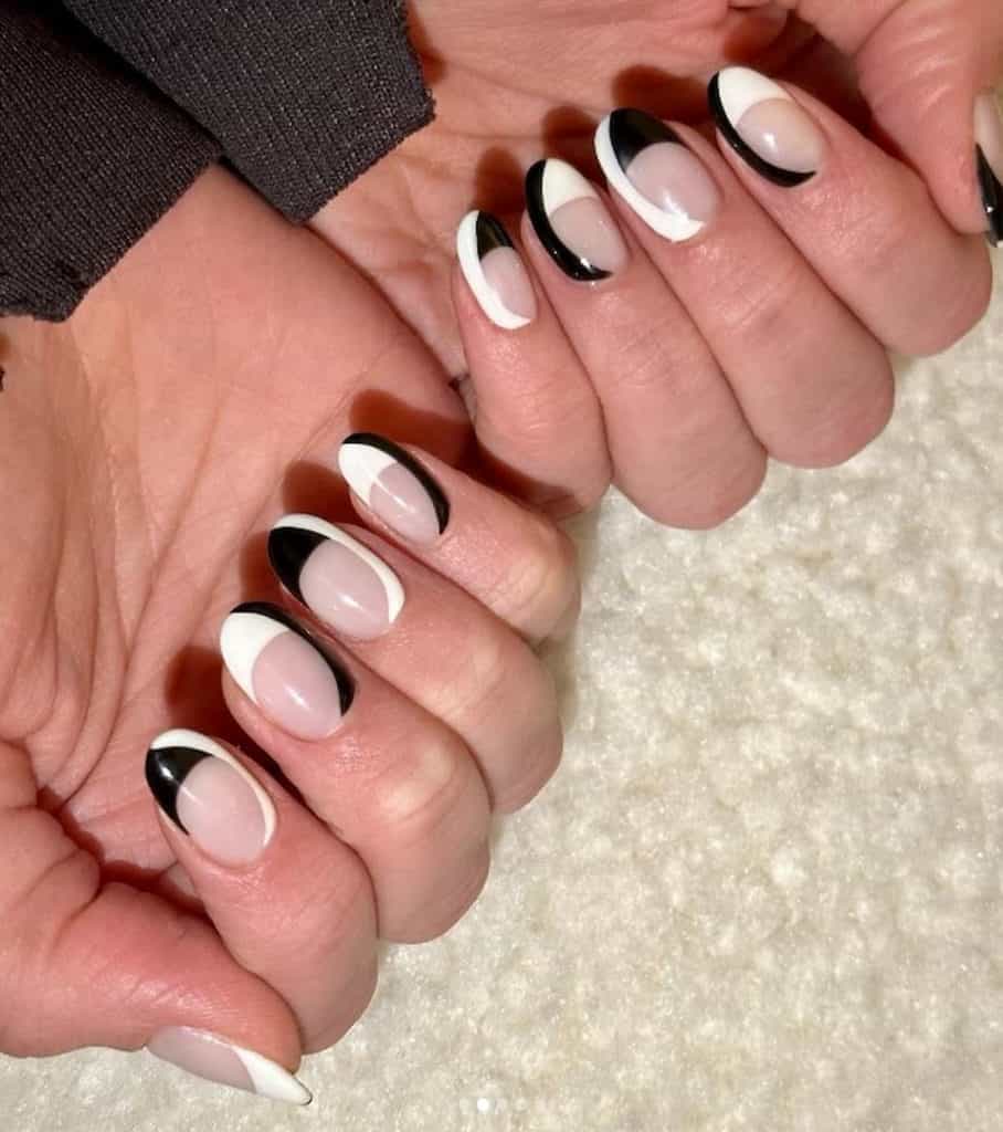 A woman's hands with nude, black and white nail colors combination 