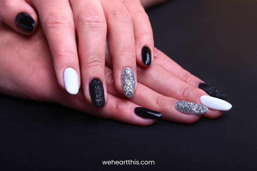 Black, white Nail art manicure. Holiday style bright Manicure with sparkles. 