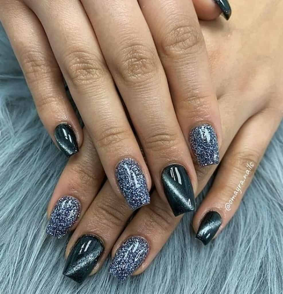 A closeup of a woman's hands with a combination of silver glitters and black nail polish that has a glittery line nail designs on select nails