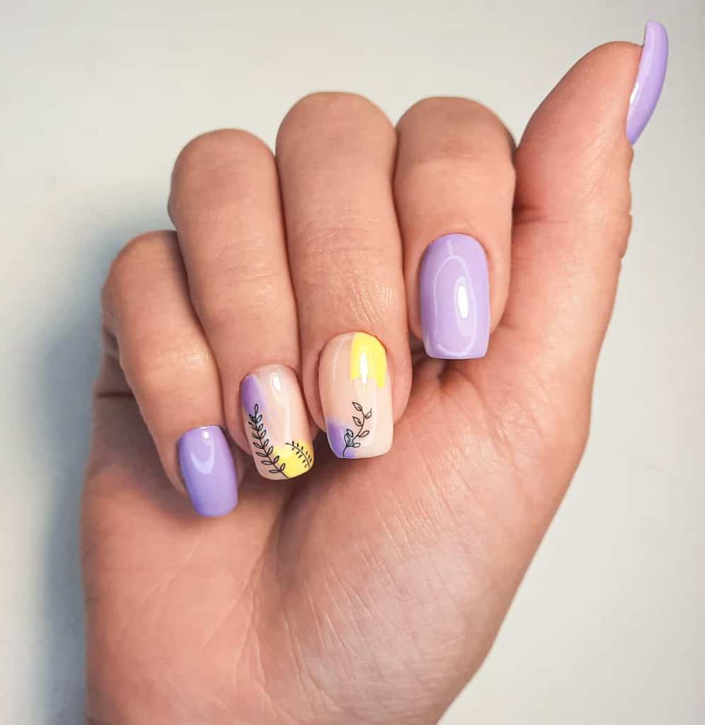 A woman's hand with a pastel yellow and lavender nail art isolated on a white background