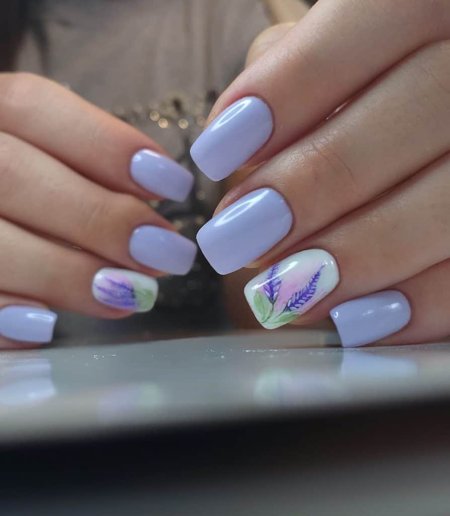A woman's hands with a combination of lavender and white gel nails and lavender flower designs