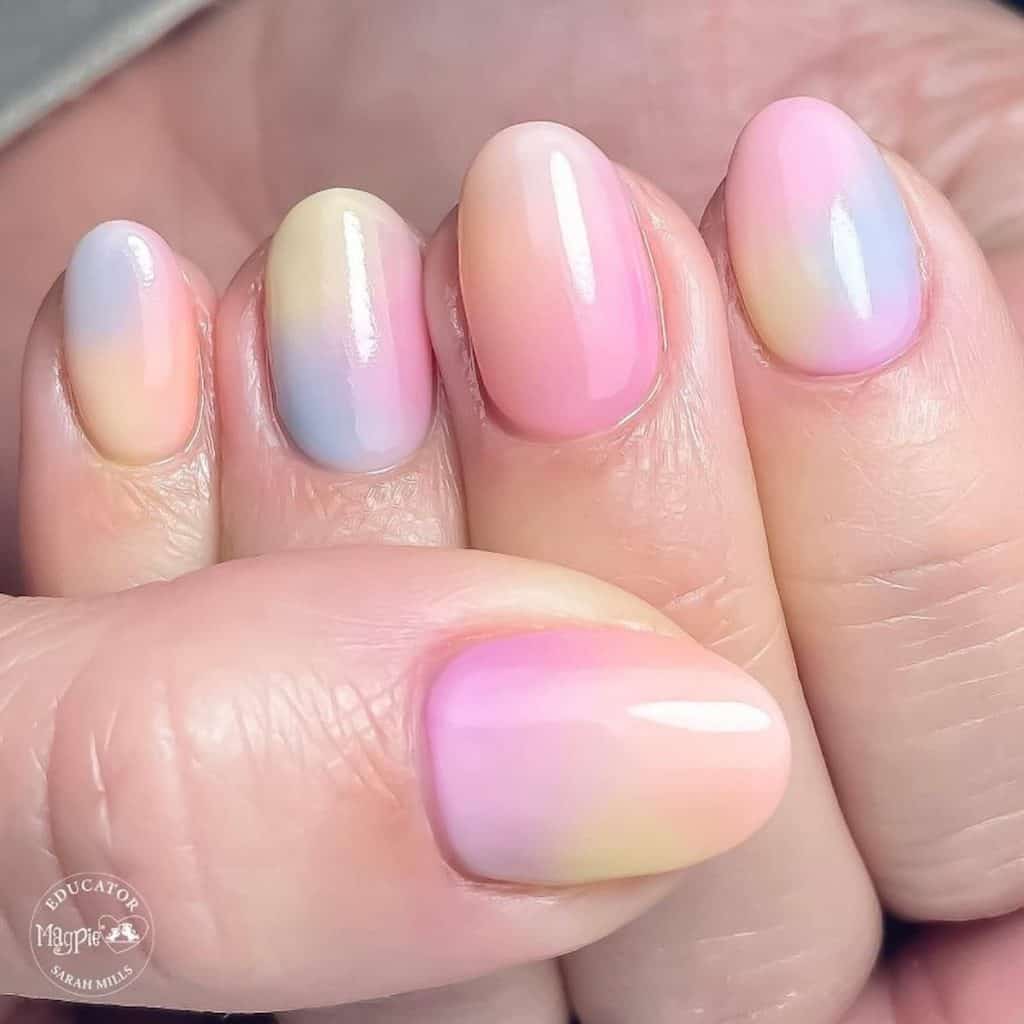 A closeup of a woman's hand with multicolored nail polish 