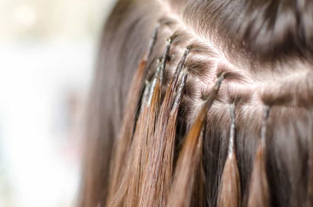 A closeup of a woman's brown hair with hair extensions
