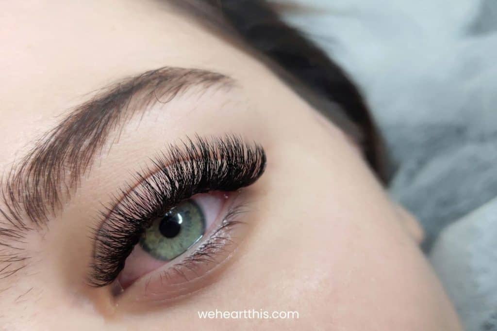 A closeup of a woman's one eye with beautiful long eyelashes 