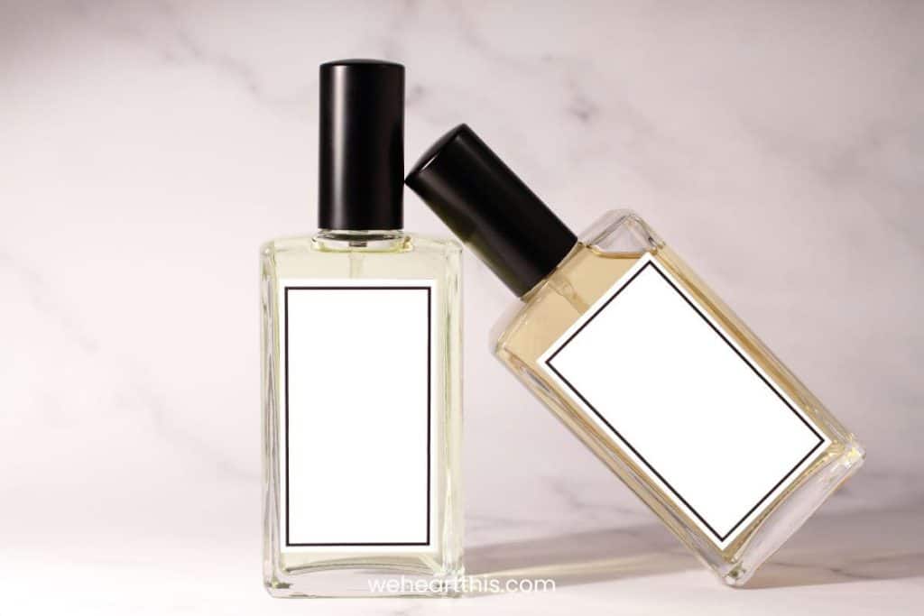 Two small bottles of perfume oil isolated on a white background