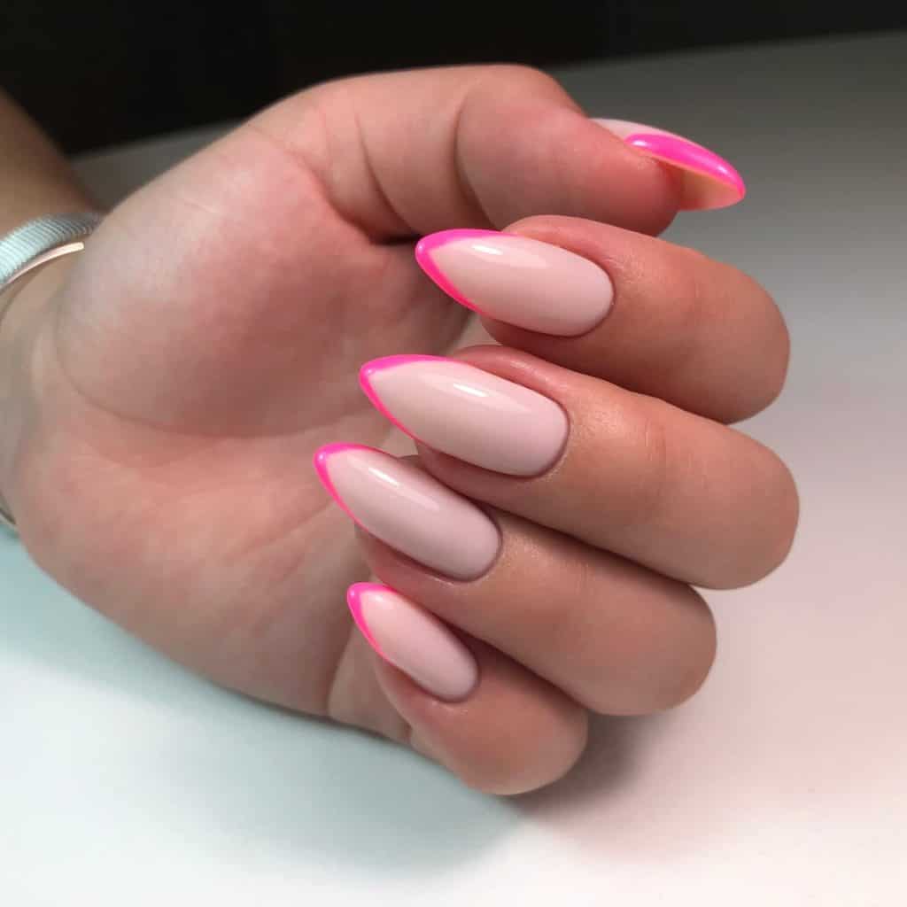 A woman's hand with pink and white nails.