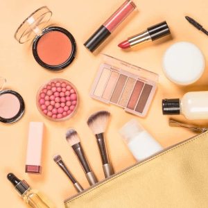 A photo of cosmetics in a bag on a yellow background.
