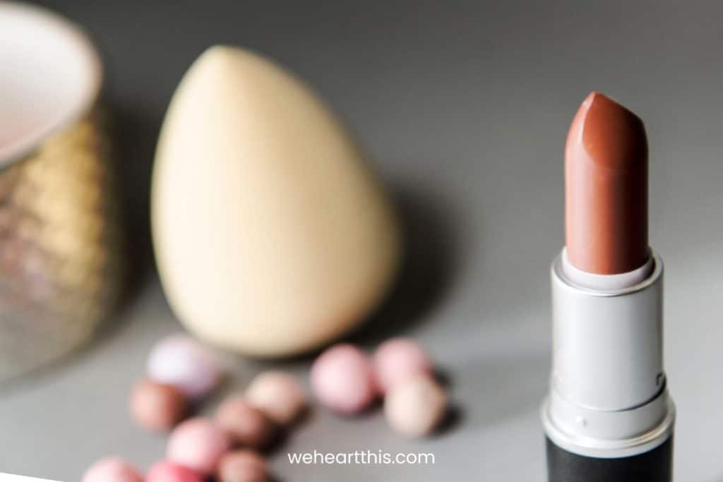 Nude lipstick on a gray and blurred background
