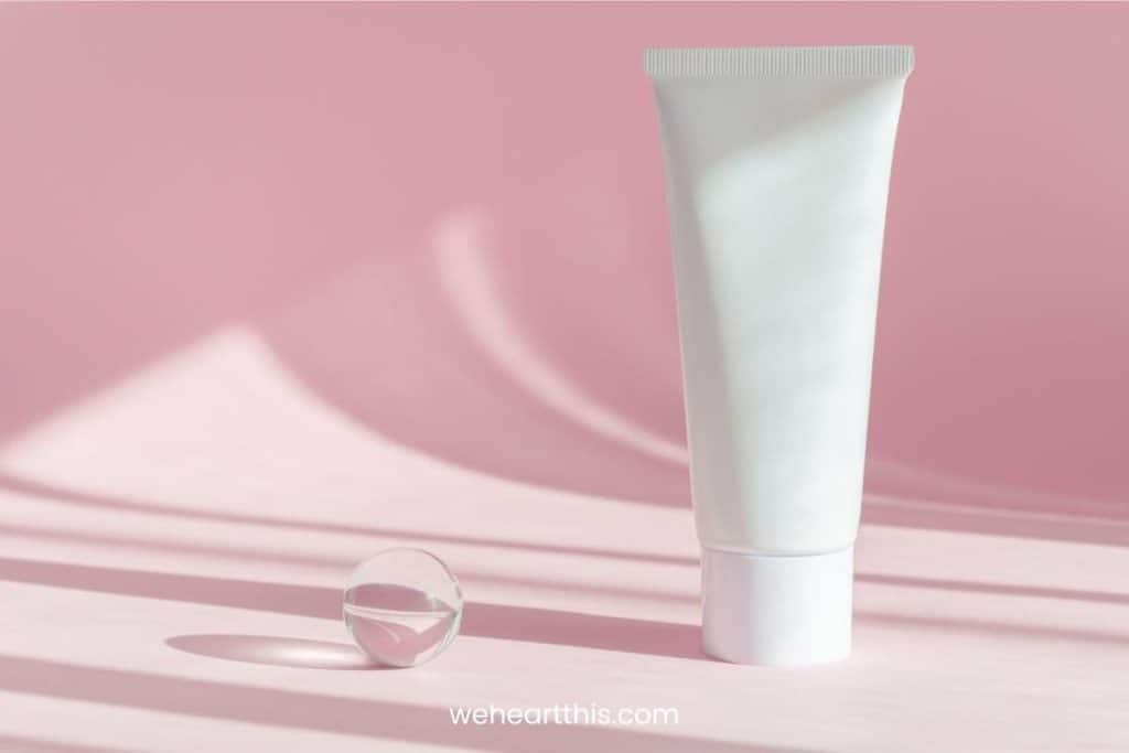White face wash tube, medium sized on a pink shadow background 