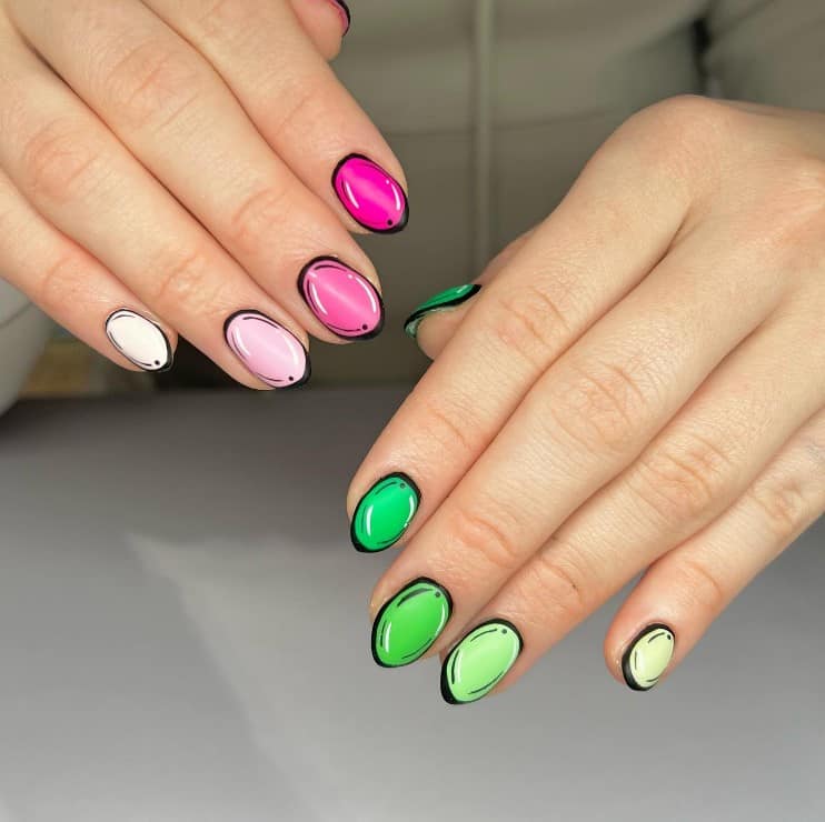 A woman's beautiful fingernails with a bright pink and green pop art-inspired nail polish