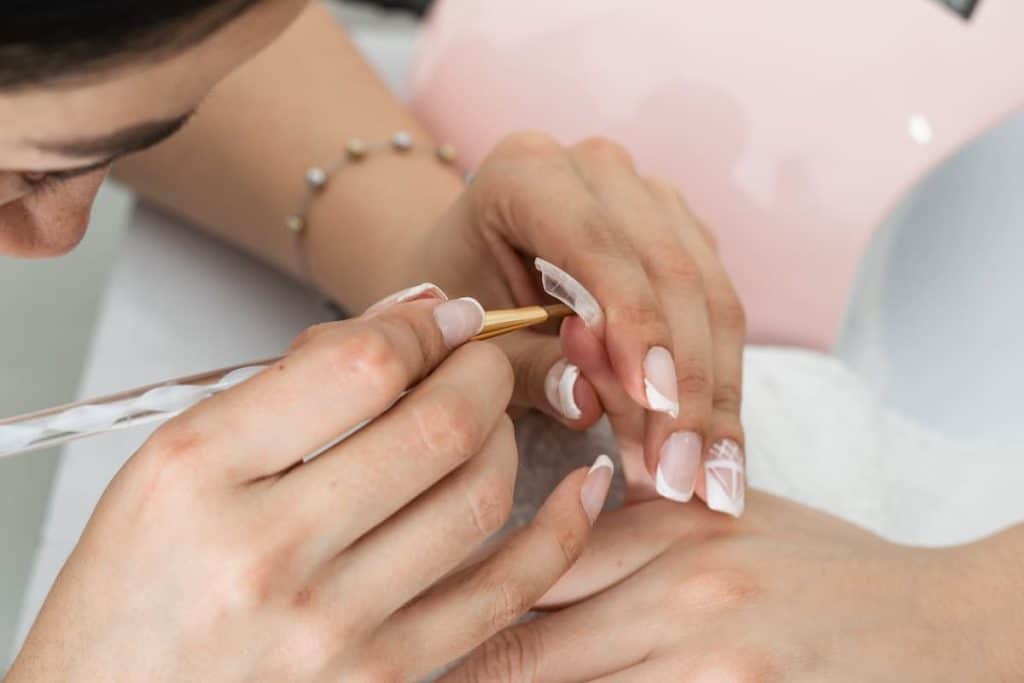 A woman getting her nails done at a nail salon.