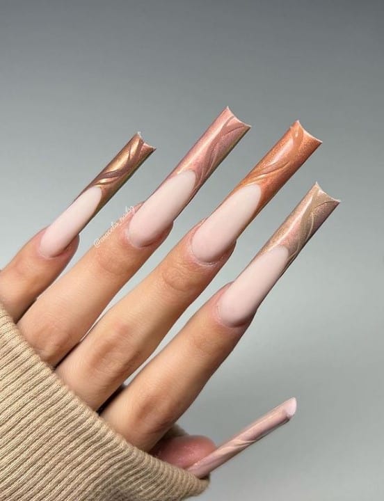 A woman's fingernails with a nude nail polish base that has shimmery 3D wavy lines in multicolored nail tips