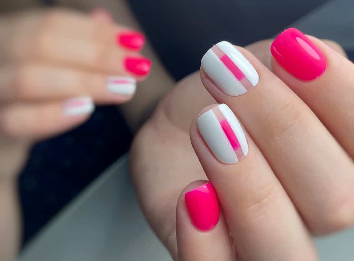 neon pink and white nail on fingernails