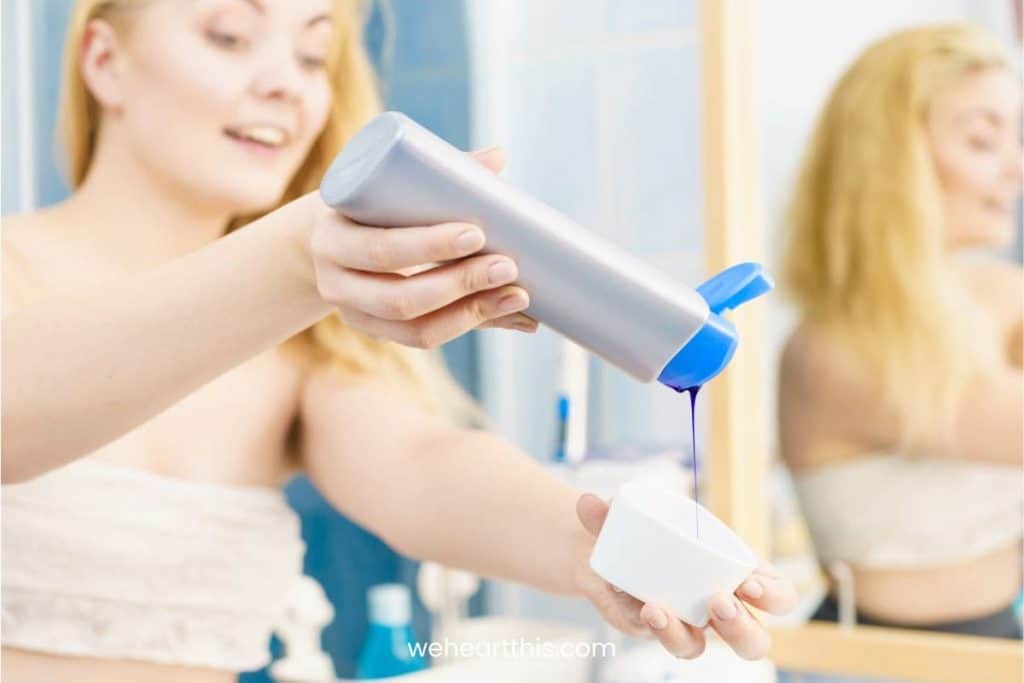 A blonde woman pouring purple shampoo into a white bowl