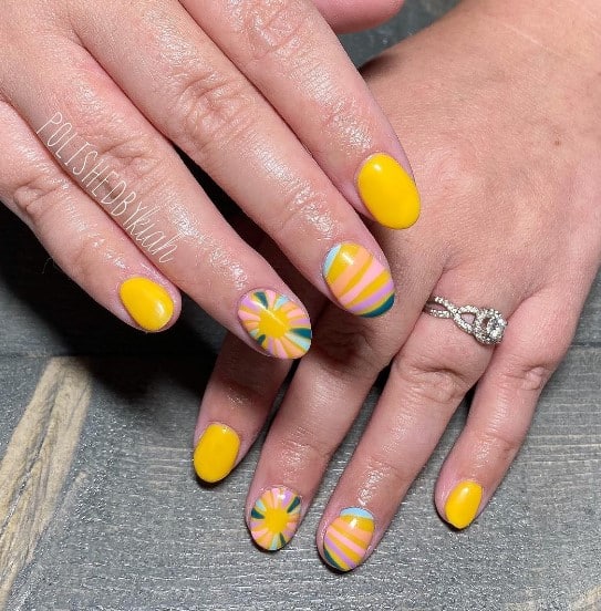 A woman's short nails with sunny yellow nail polish base that has irregular lines nail design on select nails 
