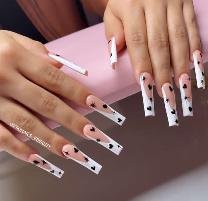 extra long square-shaped nails featuring classic French tips with black hearts and sparks all over