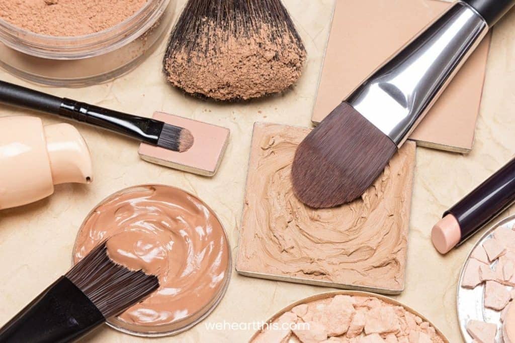 different shades of liquid and powder foundation in a table with their respective brushes