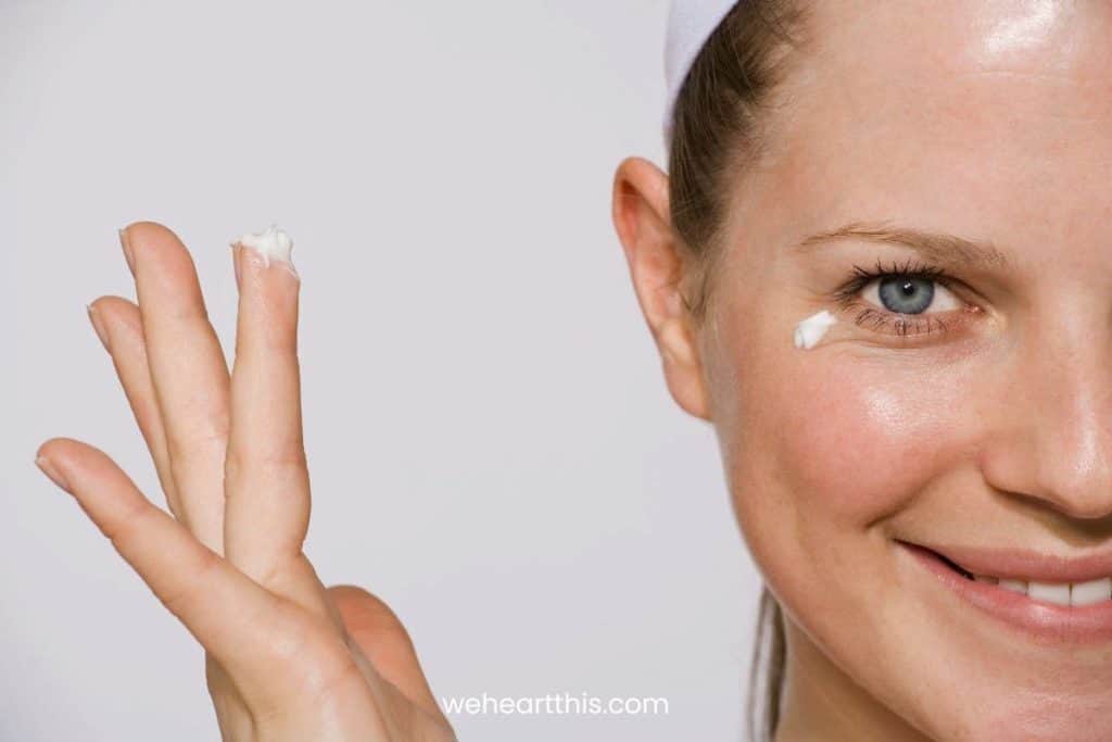 a woman applying pea sized amount of tretinoin cream on her undereye
