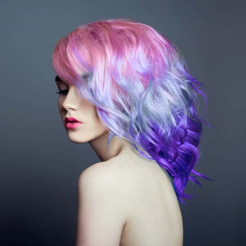 hairstyle starts with a radiant pink which gorgeously transitions into a dazzling platinum blue before finally fading into a lovely lilac hue at the tips
